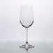 A clear Stolzle Chardonnay wine glass on a reflective surface.