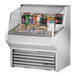 A True stainless steel horizontal refrigerated air curtain merchandiser with food and drinks on display.