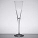 A Stolzle flute wine glass with a long stem on a table.
