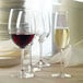 A group of Stolzle Bordeaux wine glasses on a table in a winery cellar.