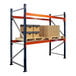 A blue and orange Interlake Mecalux heavy-duty metal pallet rack with boxes on a shelf.