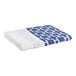 A folded blue and white 1888 Mills full size top sheet with a chain link pattern.