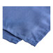 A blue fabric bed skirt with a stitched edge.