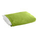 A folded green bed skirt on a white surface.