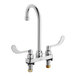 A silver American Standard deck-mount faucet with two wrist blade handles.