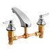 An American Standard deck-mount faucet with brass and chrome finishes and lever handles.
