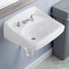 A close up of a white American Standard wall-mount bathroom sink with silver faucets.