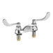 An American Standard deck-mount faucet with chrome and wrist blade handles.