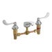 An American Standard deck-mount faucet with brass handles and a chrome finish.