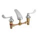 An American Standard deck-mount faucet with two brass handles.