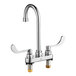 An American Standard chrome deck-mount faucet with two wrist blade handles.