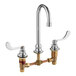 An American Standard chrome deck-mount faucet with two brass handles.