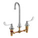 An American Standard chrome deck-mount faucet with two brass handles.