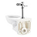 An American Standard white wall-mounted toilet with a manual metal flush valve.