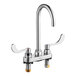 A silver American Standard deck-mount faucet with two wrist blade handles.