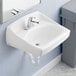 A white American Standard wall-mount commercial bathroom sink with a faucet and wall hanger.