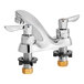 An American Standard deck-mount faucet with chrome and black and gold lever handles.
