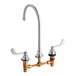 An American Standard deck-mount faucet with 8" centers and wrist blade handles.