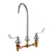 An American Standard chrome deck-mount faucet with two brass handles.