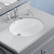 An American Standard white vitreous china Ovalyn undermount sink with a faucet.