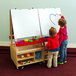 A boy and girl drawing on a Whitney Brothers wood art center white board.