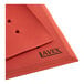 A red Lavex heavy-duty rubber floor mat with drainage holes.