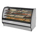 A True curved glass stainless steel dry bakery display case filled with different types of pastries.