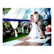 A man in a suit dancing with a woman in a white dress on a California portable New England plank and white checker composite laminate dance floor.