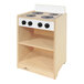 A Whitney Brothers white wooden toddler stove with black knobs on a shelf.