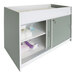 A green and white Whitney Brothers infant changing table with shelves.