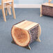 A Whitney Brothers small wood log bench with a tree stump on it.