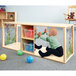 A toddler playing with balls in a wooden cabinet with acrylic panels.