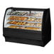 A True curved glass black dry bakery display case filled with pastries.