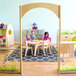 Children playing in a playroom with a Whitney Brothers wood divider archway.