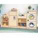 A wooden Whitney Brothers toddler play kitchen set with a door open showing a washing machine inside.