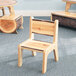 A Whitney Brothers wooden chair with a live edge wood seat.