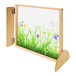 A wooden divider panel with a nature scene of grass and flowers in a wooden frame.