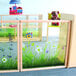 A Whitney Brothers wooden divider panel in a child's playroom with a grassy area.