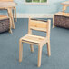 A Whitney Brothers wooden chair with a live edge seat.