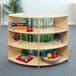 A wooden shelf with toys and books.