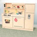 A Whitney Brothers wooden toy kitchen with a sink and refrigerator.