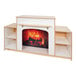 A Whitney Brothers white wood fireplace with storage shelves in a room with a fire inside.