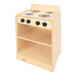 A Whitney Brothers natural wooden toddler stove with black knobs on a shelf.