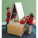 A boy and girl using a Whitney Brothers mobile wood art center with an easel and chalkboard.