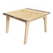 A Whitney Brothers wooden table with a live edge and legs.