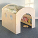 A wooden toy house with a window and a book shelf.