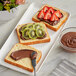 Two slices of Brioche Gourmet plant-based bread with chocolate spread and strawberries on a plate.
