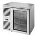 A True stainless steel back bar refrigerator with a glass door.