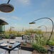 A Bromic Matte Black Eclipse portable patio heater on a table at a restaurant