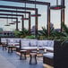 A table on a large outdoor patio with a Bromic Heating ceiling mount pole for Eclipse heaters.